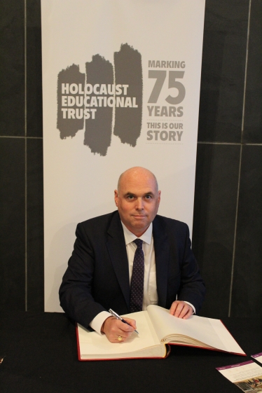 Paul Davies signing the Holocaust Book of Commitment